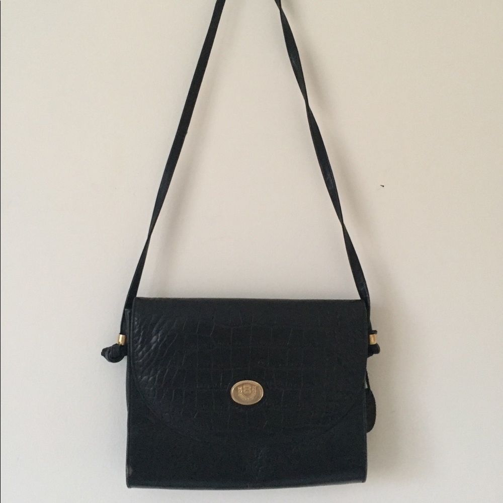 Vintage black handbag with flap and gold emblem